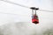 Red funicular or red suspension cable car to Lomnicky peak in fog or clouds, September 2020, High Tatry, Slovakia