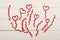 Red fuzzy wire hearts and ringlets on white vintage background