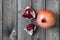 Red garnet with pieces on grey wooden background.