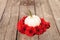 Red gerbera daisies ring a carved white Casper pumpkin