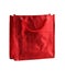 Red gift bag isolated on the white background. It is a small bag with an embossed pattern. It is intended for shopping or for