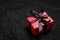 Red gift box with black ribbon on a black lace background