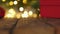 red gift box Christmas tree garland defocused blurred lights wooden background