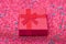 Red gift box in festive tinsel