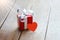 Red gift box and heart on white wooden table