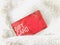 A red gift card on white Faux fur.