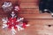 Red gift seasonal with red and white snow flake, round glass, plant, special present for winter holiday on the wooden board