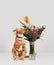 Red ginger cat smelling an arrangement of flowers