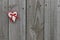 Red gingham and muslin hearts hanging on wood door