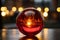 a red glass ball sitting on a table