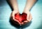 Red glass heart in woman hands