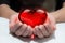 Red glass heart in woman hands