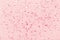 Red glitter mica sparkles on pink pastel trendy abstract background