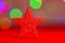 Red glittery decoration in a colorful Christmas composition isolated on background of blurred lights