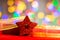 Red glittery decoration in a colorful Christmas composition isolated on background of blurred lights