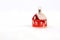 Red glossy Christmas decoration - little house standing on white fur background
