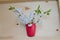 Red glossy glass with branches of blooming cherry