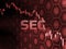 Red glowing text on candle stick chart with bitcoin and alt coins background. SEC delays decision approving ETF fund