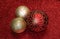 Red and Gold Christmas Ornaments on Red Glitter Background