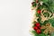 Red and gold decorations, branches of a Christmas tree and a garland on a white background