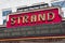 A red and gold neon sign over the Earl and Rachel Smith Strand Theatre in the Marietta Square in Marietta Georgia