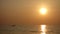 Red Golden Ocean Sunset with Fishing Boat on Horizon