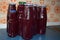 red grape juice in rused mixed bottles