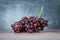 Red grape on wooden table - Bunch of grapes juicy fruit on light and dark background