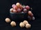 Red grapes in black bowl with walnuts