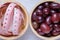 Red grapes and tape measure in wooden bowl.