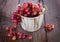 Red grapes in a vintage wooden bucket on wooden background