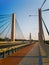 Red and gray pavement on huge Millennium bridge with large pillars in Wroclaw