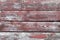 Red-gray wooden background. horizontal boards. old paint peels off. old boards. Red gray wood texture of a worn painted board. Red