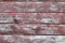 Red-gray wooden background. horizontal boards. old paint peels off. old boards. Red gray wood texture of a worn painted board. Red