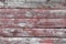 Red-gray wooden background. horizontal boards. old paint peels off. old boards. Red gray wood texture of a worn painted board. Red
