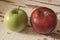 Red and green apples on the white barn wood background..
