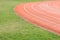 Red and green. Athletic field with green grass