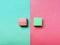 Red and green background divided diagonally with two matching color cubes