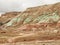 Red, green and brown rock layers eroding