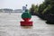 Red green buoy in the waterway marking that both sides can be used in river Noord in The Netherland