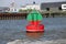 Red green buoy in the waterway marking that both sides can be used in river Noord in The Netherland