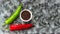Red, green cayenne hot chili, black pepper on black, white background healthy eating immune concept