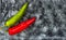 Red, green cayenne hot chili pepper on black, white background immune support healthy eating concept