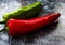 Red, green cayenne hot chili pepper on black, white background immune support healthy eating concept