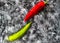 Red, green cayenne hot chili pepper on black, white background immune support healthy eating concept