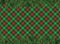 Red, green checkered pattern background with Christmas tree decoration