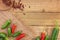 Red and green chili peppers on a rustic background viewed from the top with copy space