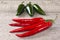 Red and Green Chilli Peppers on Weatherd Wood