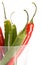 Red and green chilly peppers in glass