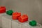 Red and green houses standing on cubes